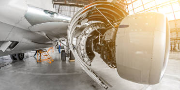 The hood of an aircraft engine open for servicing