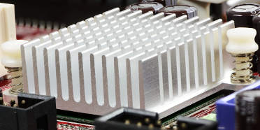 Extruded aluminum heatsink on a red printed circuit board