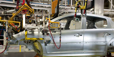 Car with aluminum and steel parts being assembled at manufacturing plant