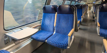 Inside a long distance train with aluminum trim on interior