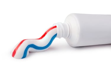 Toothpaste coming out of a tube