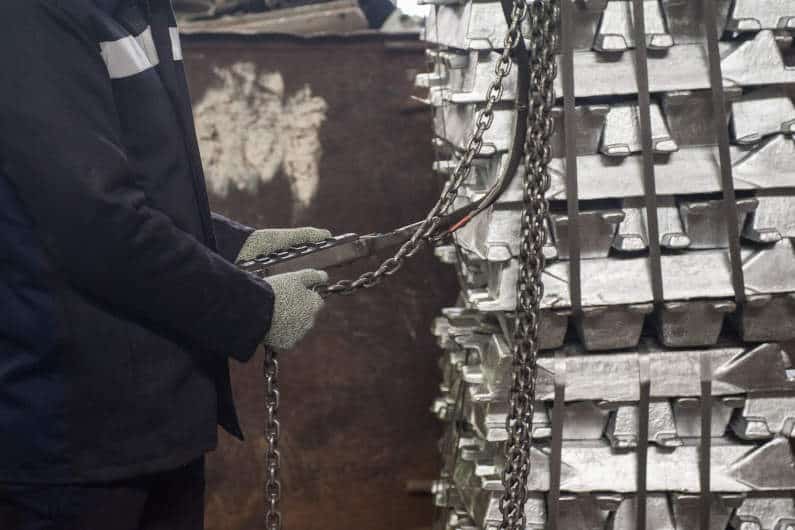 Worker moving aluminum ingots