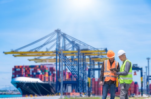 Engineers reviewing information at shipping port