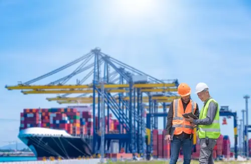 Engineers reviewing information at shipping port