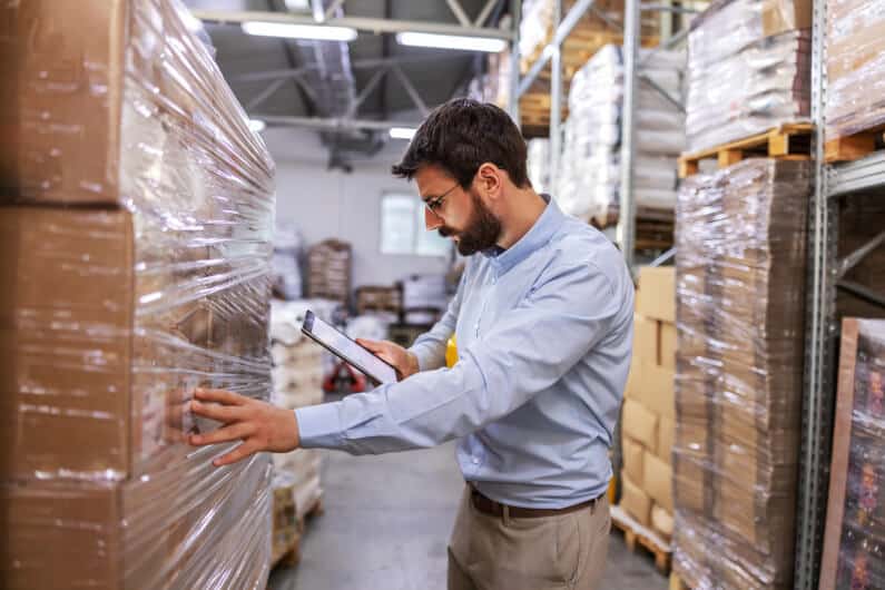 Man reviewing inventory inside warehouse