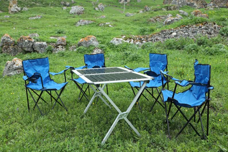 Camping kit folding metal table and four blue chairs