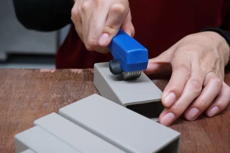 Factory QC staff conducting crosshatch test