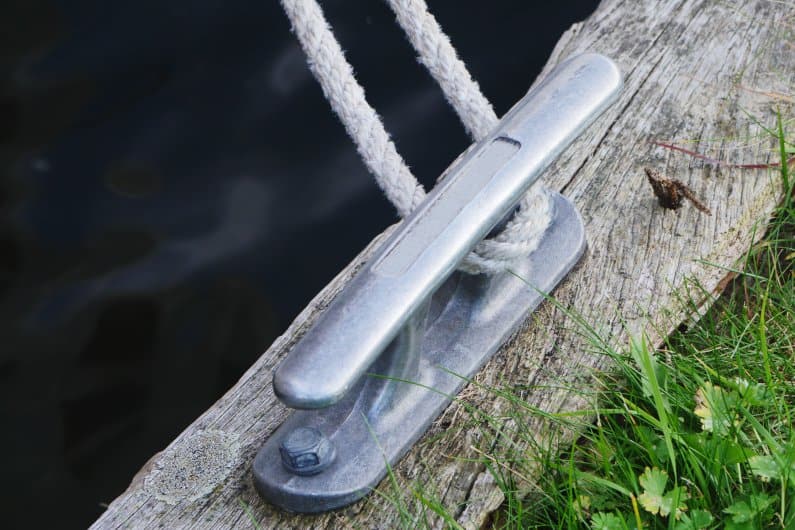 Aluminum mooring cleat on wooden plank