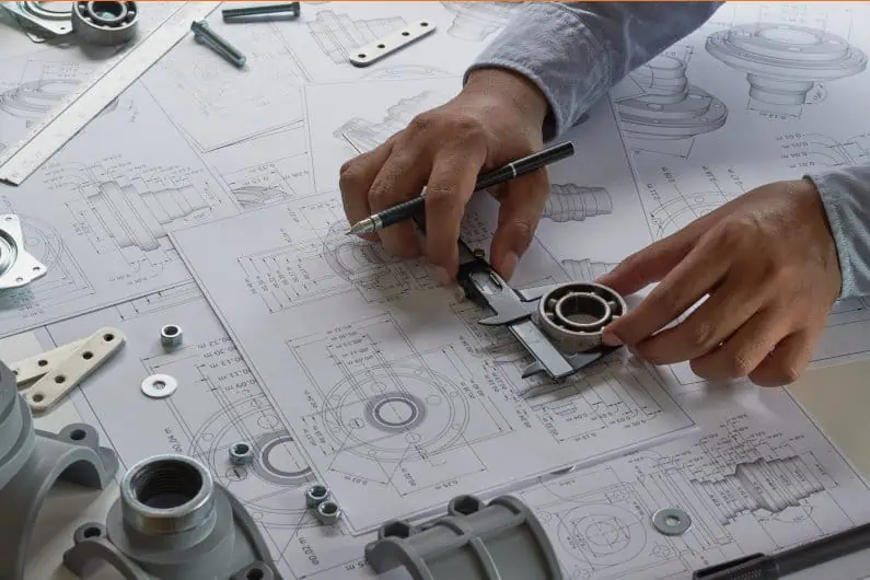 Engineer comparing parts to drawing